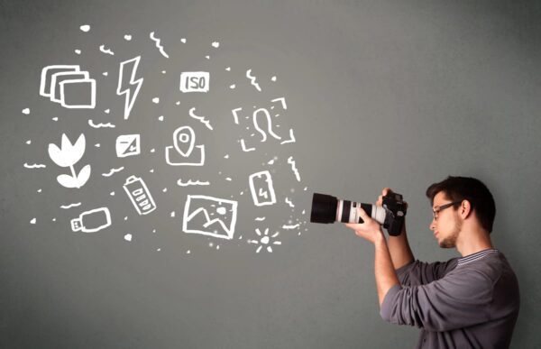 A photographer with a camera pointed at several icons representing photography in digital marketing