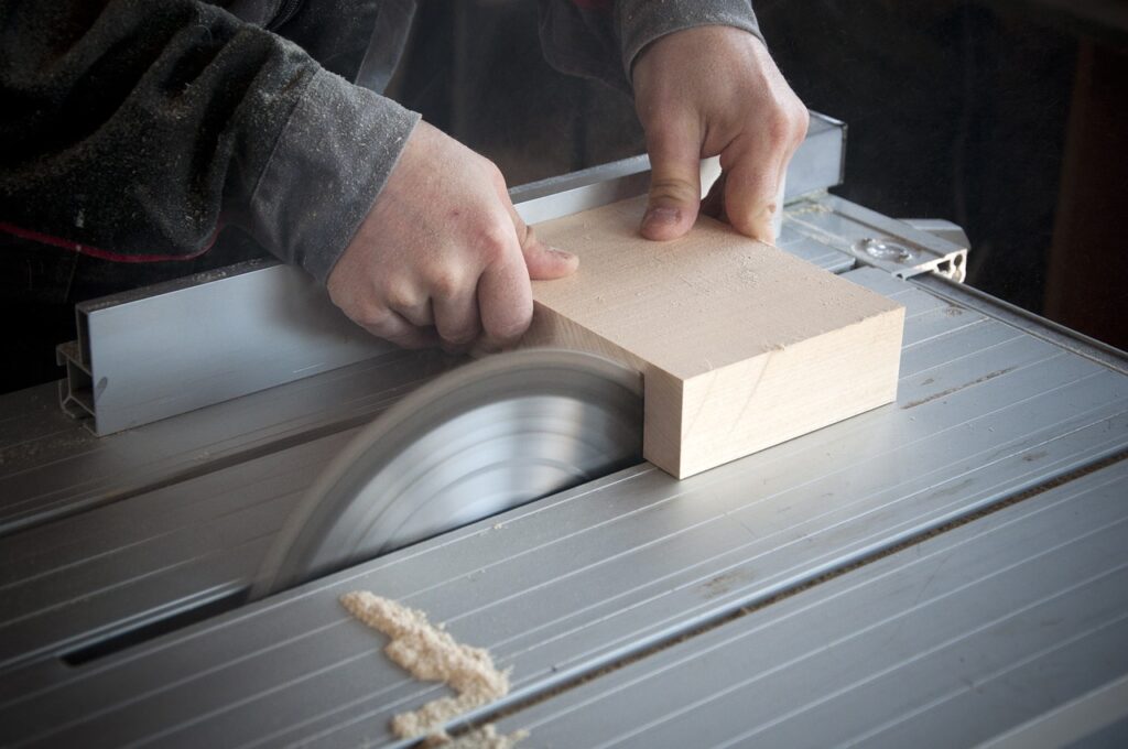 a woodworker cutting a piece of wood with a saw