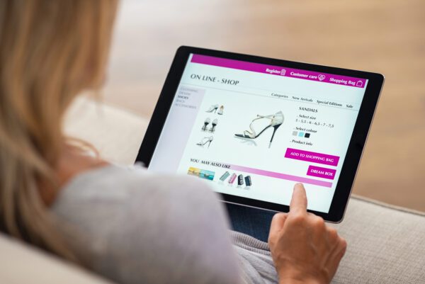 A person shopping for shoes looking at a picture, highlighting why images are important on a website