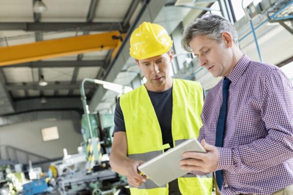 A manager looking at manufacturing website designs on the job site